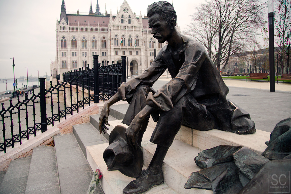 Statue of Attila Jozsef - Hungarian poet. Parliament in the background