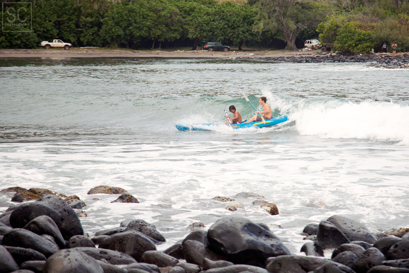 These kids were having a blast surfing in a kayak
