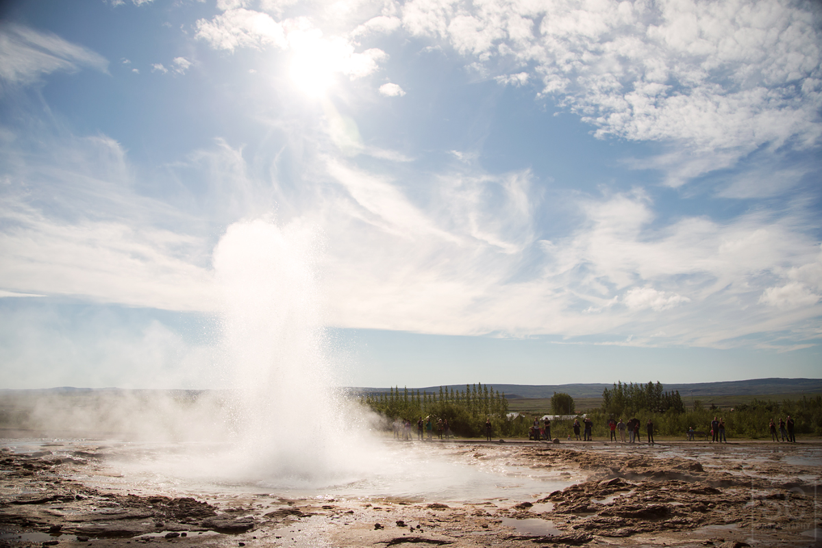 Watch Strokkur Geyser shoot hot water into the air (similar to Old Faithful in Yellowstone, only much smaller)